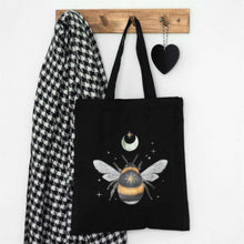 Black cotton tote bag with moon-and-bee graphic and dual fabric handles