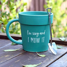 Teal plant pot style mug with shovel spoon and "I'm sexy and I MOW IT" text