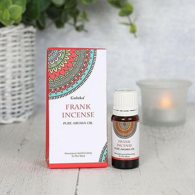 Incense aroma oil bottle with white cap and red label beside the product box