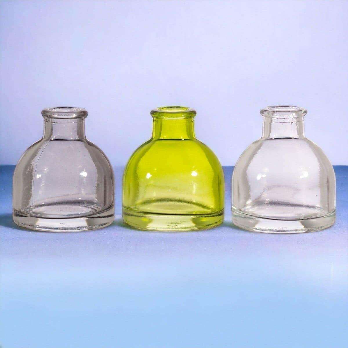 Three mini glass bud vases in smoky grey, lime green, and clear glass.