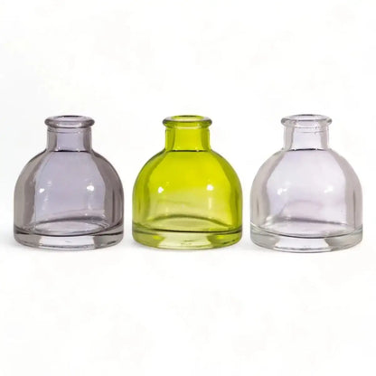 Front view of three mini glass bud vases: smoky grey, lime green, clear.
