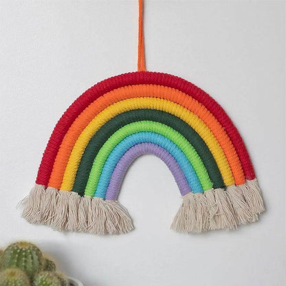 Hanging rainbow room decoration with layered rainbow stripes and beige tassel ends