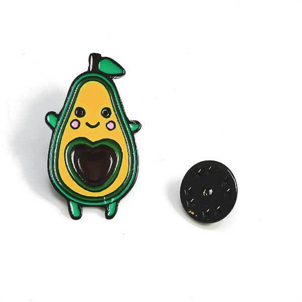 Avocado enamel pin badge with smiling face, green top leaf and dark heart backing