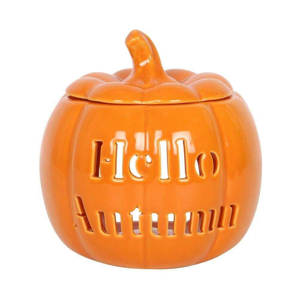 Orange pumpkin wax melt burner with carved lid and glossy finish, close-up