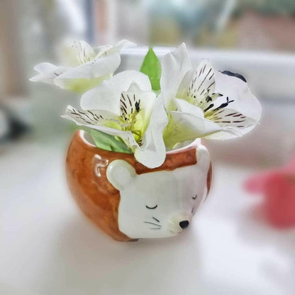 Hedgehog planter bowl with white lilies and green buds
