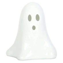 White ceramic ghost night light with two oval eye cutouts, unlit.