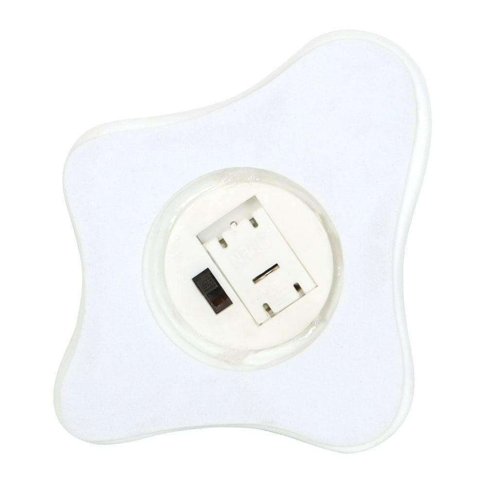 White ghost-shaped ceramic night light showing plug connection in base.