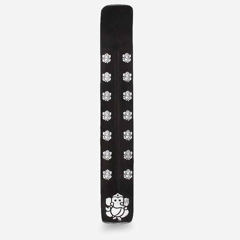 Black wooden incense stick holder with repeating lotus-style lion symbols