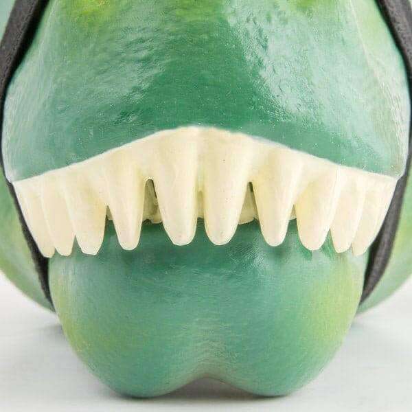 Green T-rex lunch box with white teeth and open jaw, close-up