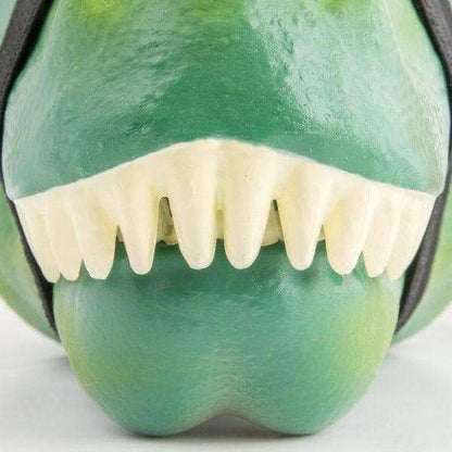 Green T-rex lunch box with white teeth and open jaw, close-up