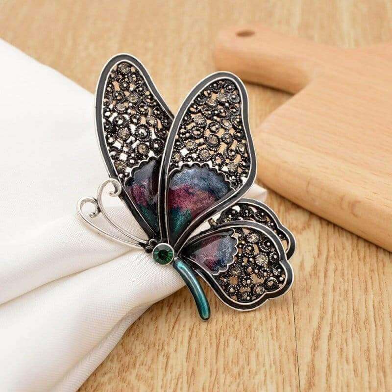 Large rhinestone butterfly brooch pin with dark wings, teal enamel stems, green center stone