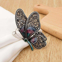 Large rhinestone butterfly brooch pin with dark wings, teal enamel stems, green center stone