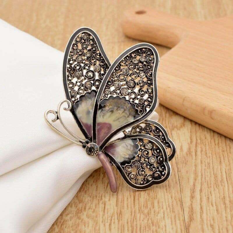 Large rhinestone butterfly brooch pin with dark wings, purple-blue enamel accents, center gem