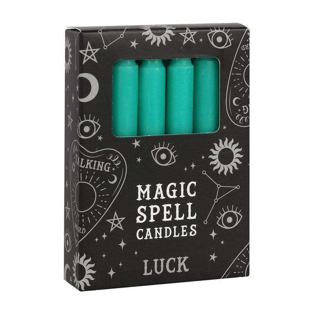 Magic spell candle box with four green candles in a front window
