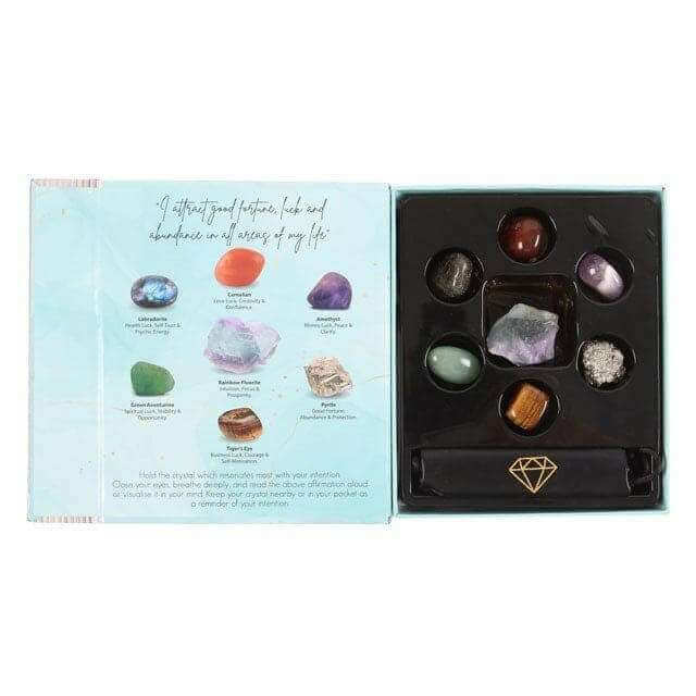 Opened crystal gift set box with card and tray of assorted stones
