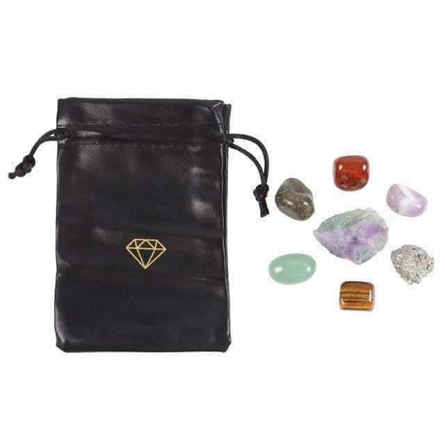 Black drawstring pouch with gold gem emblem and assorted natural crystals