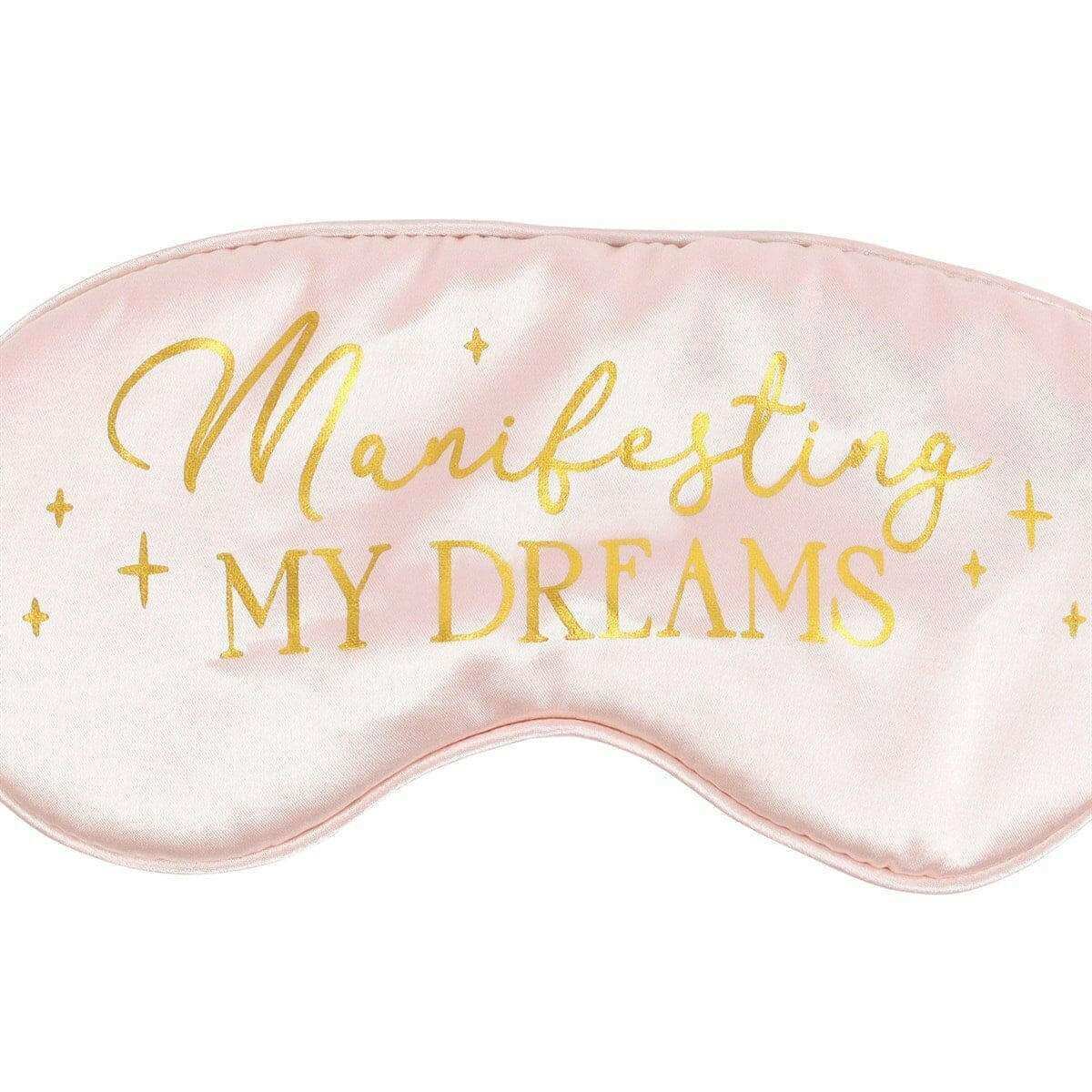 Satin sleep eye mask close-up with “Manifesting My Dreams” gold script and stars