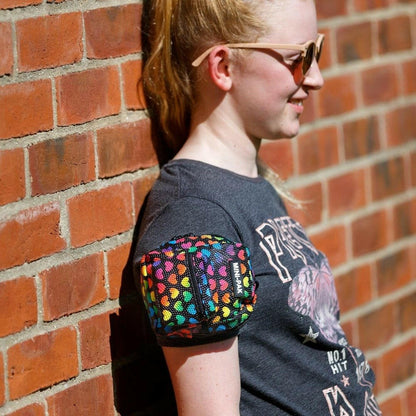 Mini backpack worn on arm, colorful heart-print front pouch with zipper