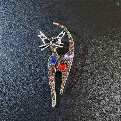 Rhinestone cat pin brooch with multicolor stones and red-blue eyes, silver tone