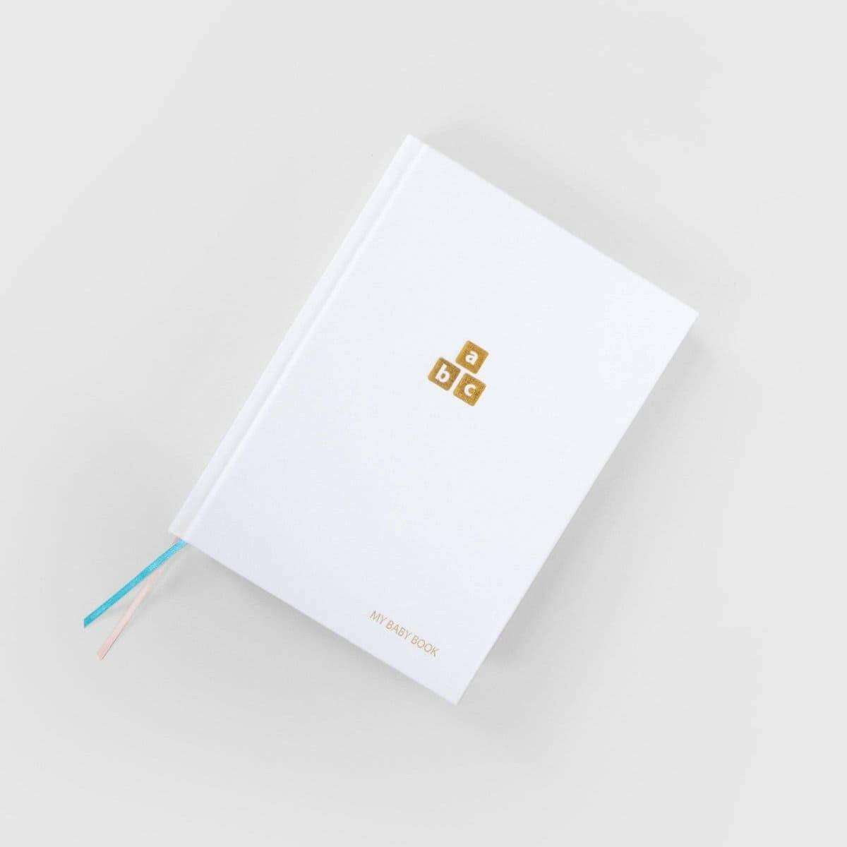 White baby years journal with ABC logo on cover and blue ribbon tie