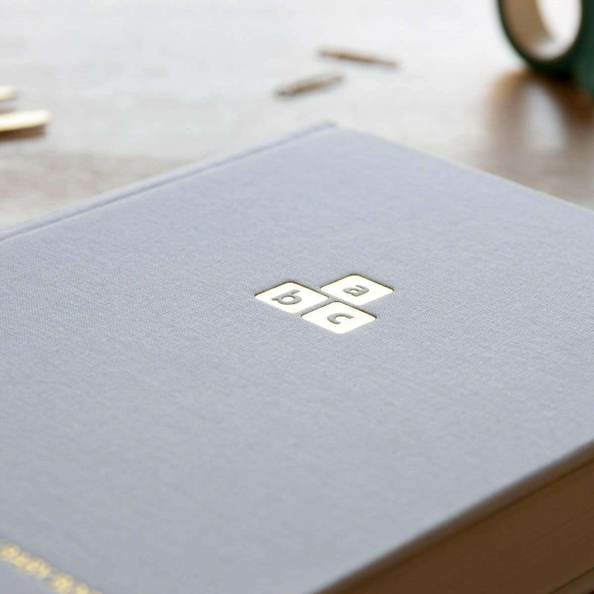 Baby years journal cover close-up with embossed square emblem