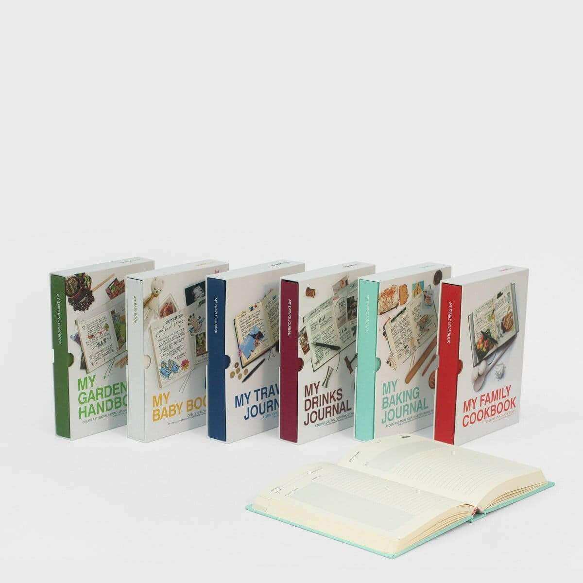 Set of baking journal books with colorful spines and an open journal in front