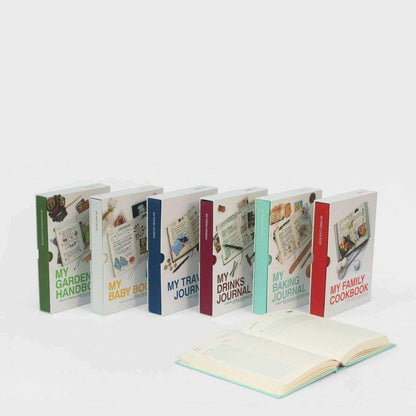 Set of baking journal books with colorful spines and an open journal in front