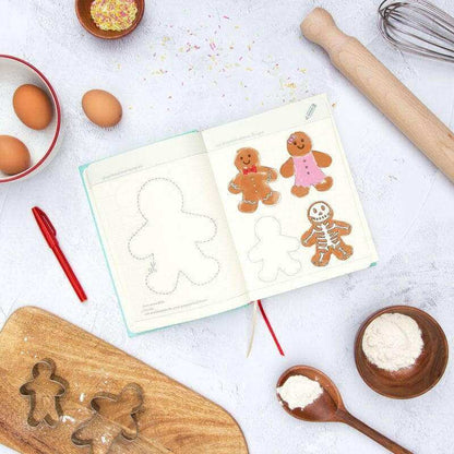Open baking journal book showing cookie outlines and gingerbread sticker illustrations