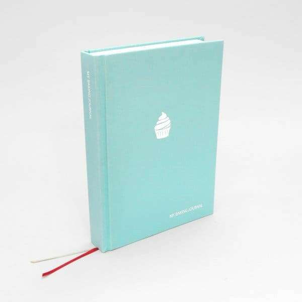 Turquoise baking journal book with a white cupcake icon on the cover