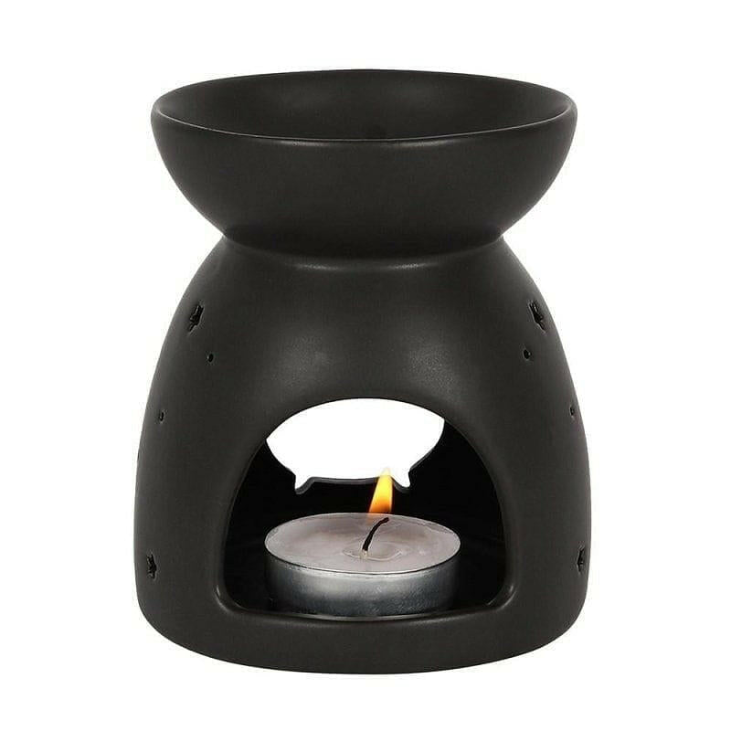 Black cauldron wax melt burner with centered flame in open window