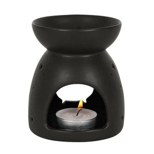 Black cauldron wax melt burner with centered flame in open window