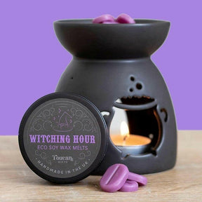 Black cauldron wax melt burner with flame, purple wax melts, and Witching Hour lid