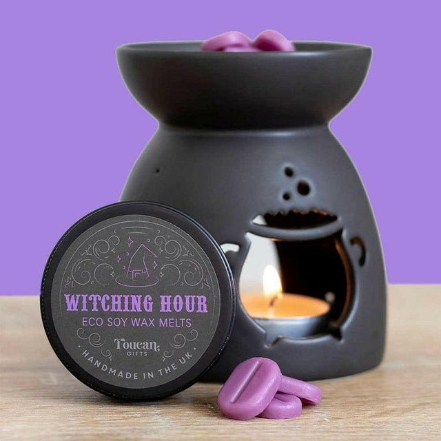 Black cauldron wax melt burner with flame, purple wax melts, and Witching Hour lid