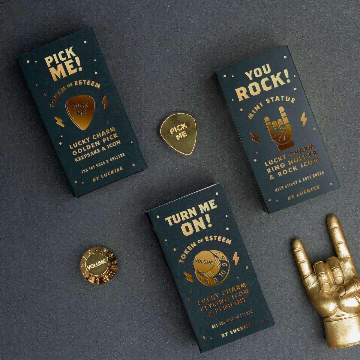 Gold-plated guitar pick charm with “Pick Me” design, shown with themed cards.