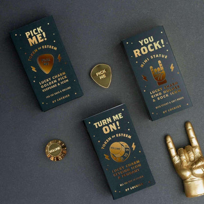 Gold-plated guitar pick charm with “Pick Me” design, shown with themed cards.