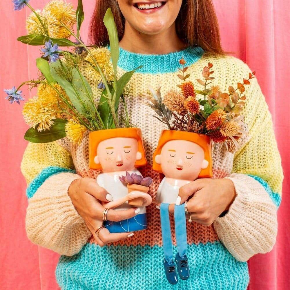 Plant mum planter with dangling legs, orange hair lady, holding a small flower pot