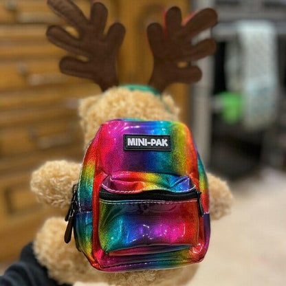 Rainbow holographic mini backpack with MINI-PAK patch and black front zip pocket.
