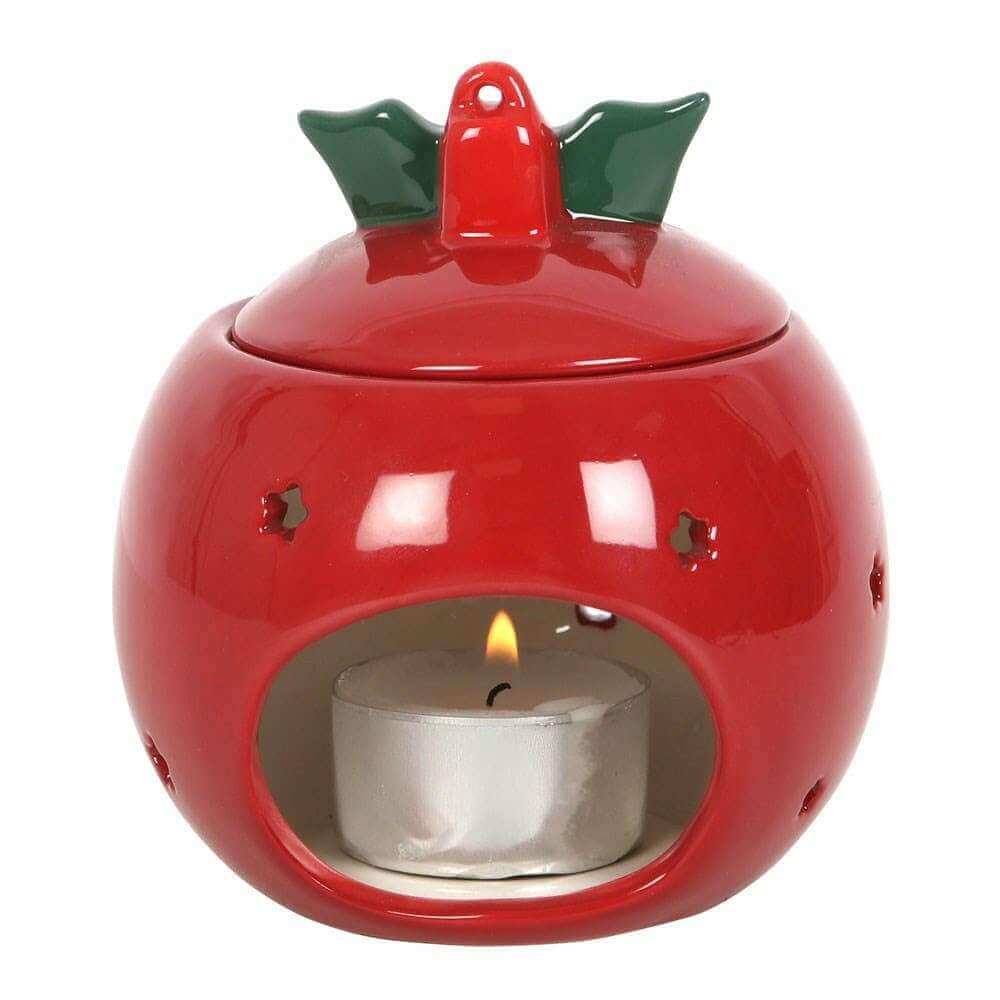Red bauble wax melt warmer with open front window showing a lit candle