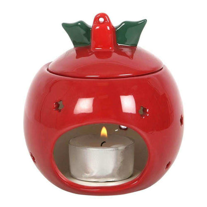 Red bauble wax melt warmer with open front window showing a lit candle