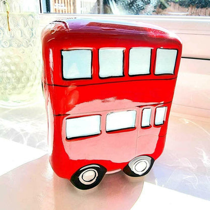 Red retro ceramic London bus money box front view with windows and wheels