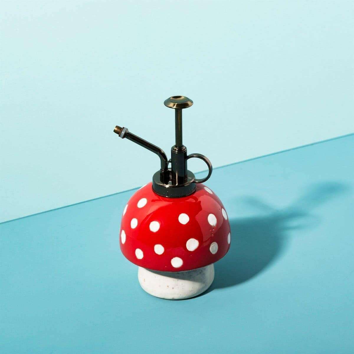 Mushroom-style plant mister, red cap with white dots, black pump, angled metal spray tube