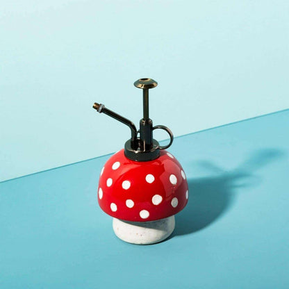 Mushroom-style plant mister, red cap with white dots, black pump, angled metal spray tube