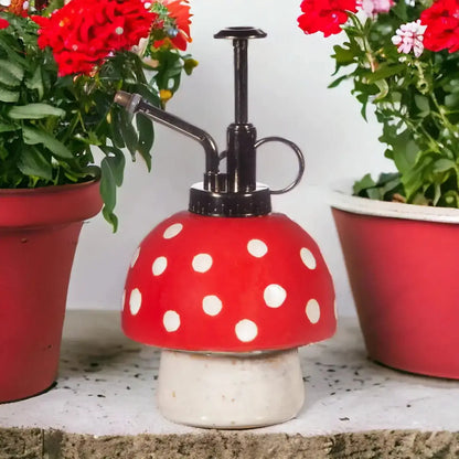 Red polka-dot plant mister with black spray head and white mushroom base