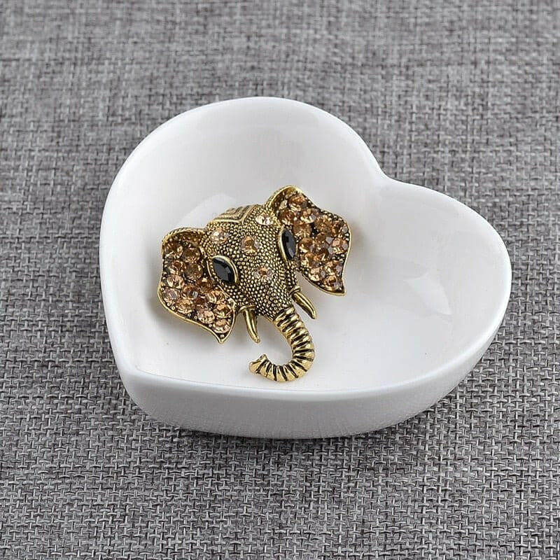 Gold elephant brooch with crystal rhinestone details, raised trunk and tusks