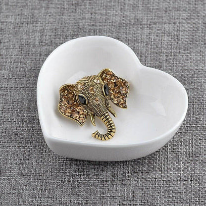 Gold elephant brooch with crystal rhinestone details, raised trunk and tusks