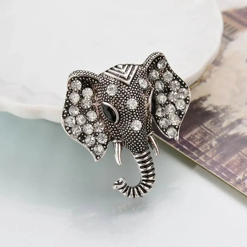 Silver elephant crystal brooch with rhinestone accents and curled trunk tip