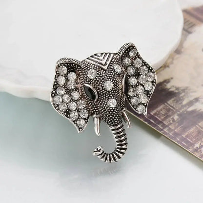 Silver elephant crystal brooch with rhinestone accents and curled trunk tip