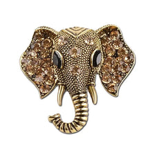 Gold elephant crystal brooch with rhinestone eyes and raised trunk detail