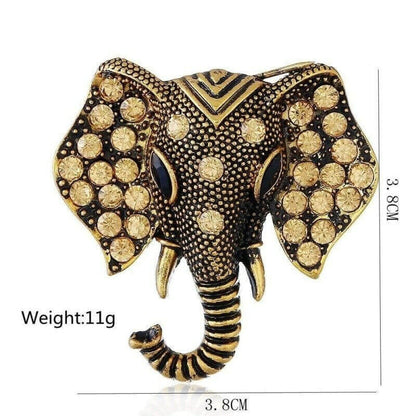 Gold elephant brooch with rhinestone pattern and striped trunk, centered view