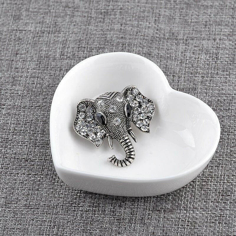 Silver elephant crystal brooch on a white heart-shaped dish